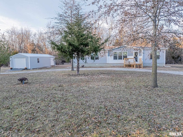 view of yard featuring a garage and an outbuilding