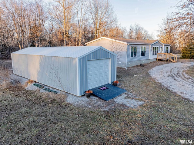 view of outbuilding with driveway and an outdoor structure