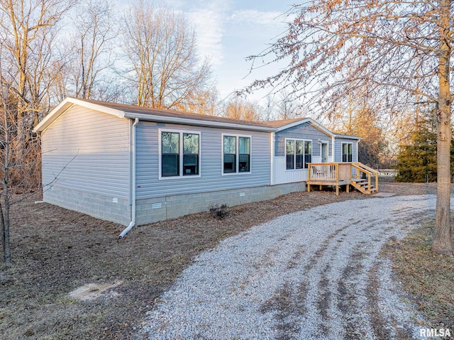 view of front of house with crawl space, driveway, and a wooden deck