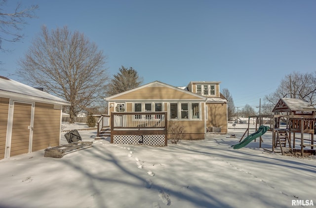 rear view of house featuring a playground