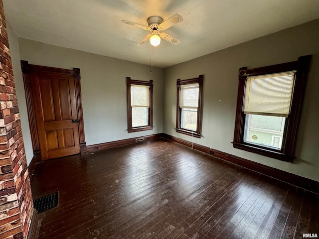 unfurnished room with visible vents, ceiling fan, hardwood / wood-style flooring, and baseboards