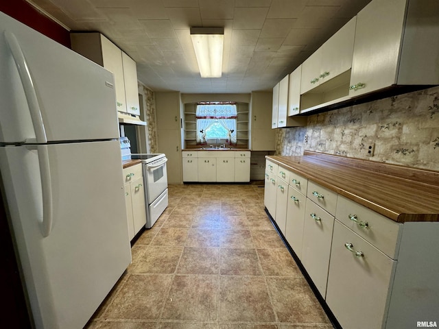 kitchen featuring under cabinet range hood, white appliances, a sink, white cabinetry, and open shelves