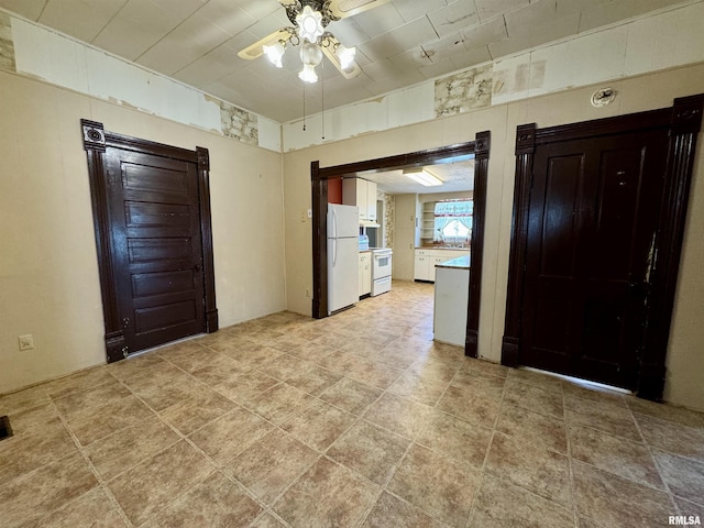 interior space with ceiling fan