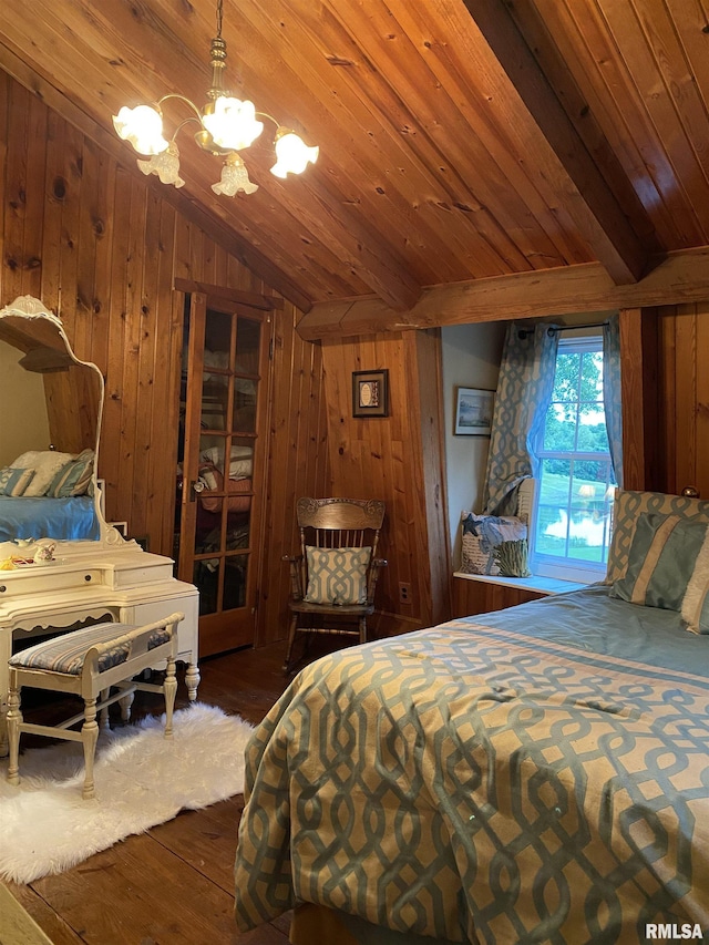 bedroom featuring wooden walls, wood ceiling, wood finished floors, vaulted ceiling, and a chandelier