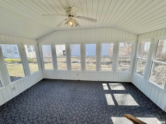 unfurnished sunroom with a healthy amount of sunlight, wooden ceiling, ceiling fan, and vaulted ceiling