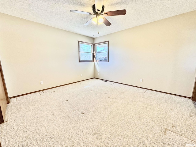 unfurnished room with a textured ceiling, baseboards, and light colored carpet