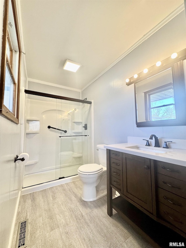 full bathroom with crown molding, visible vents, toilet, a shower stall, and vanity