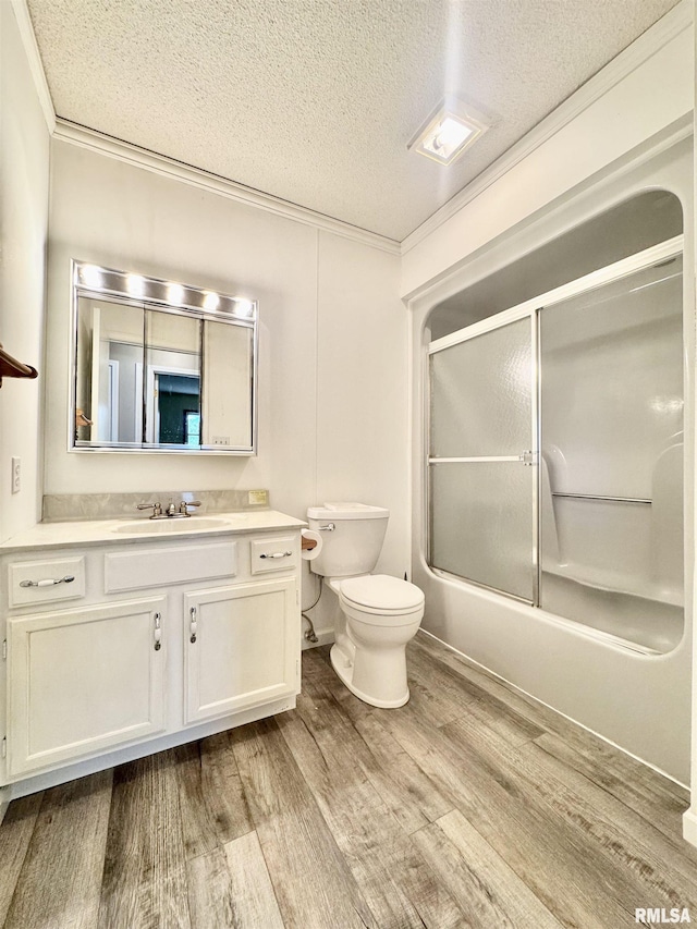 full bathroom featuring toilet, enclosed tub / shower combo, vanity, a textured ceiling, and wood finished floors