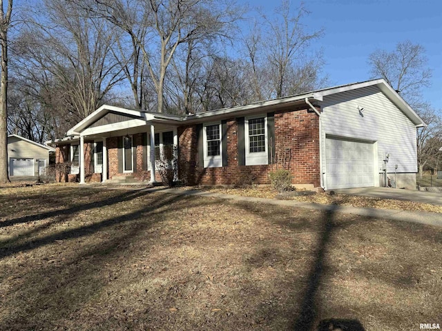 view of front facade featuring a garage, concrete driveway, and brick siding