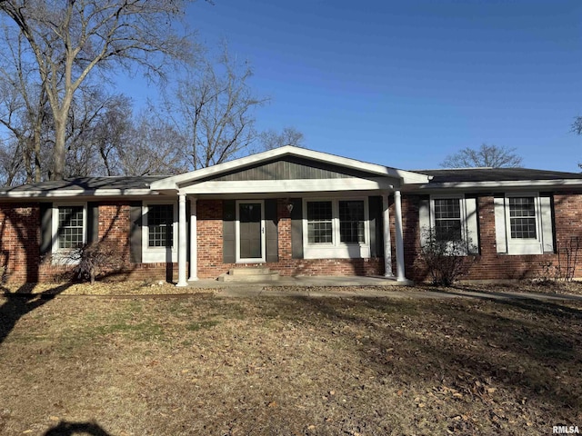 single story home featuring brick siding