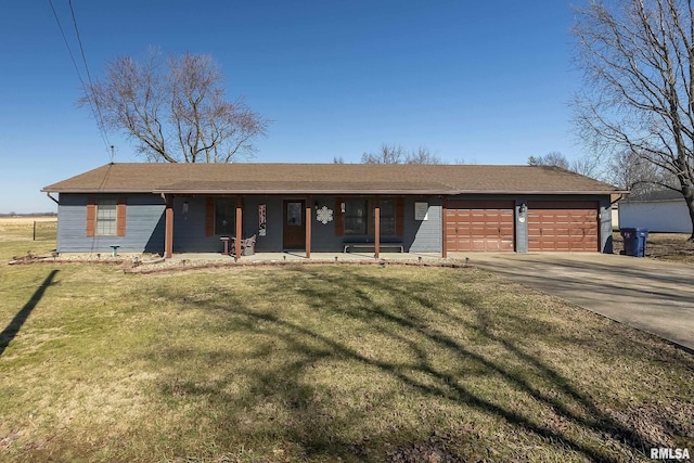 ranch-style home featuring covered porch, driveway, an attached garage, and a front yard