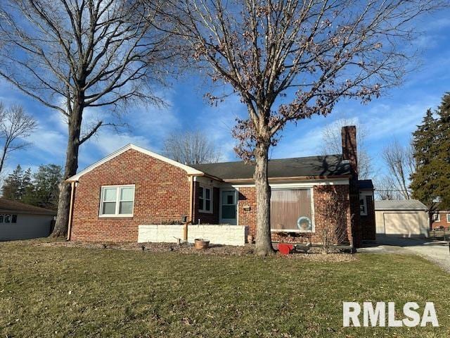 exterior space with a front yard, an outbuilding, brick siding, and a chimney