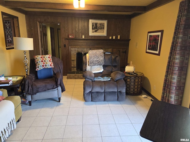 living area featuring a fireplace, beamed ceiling, wood walls, and light tile patterned flooring