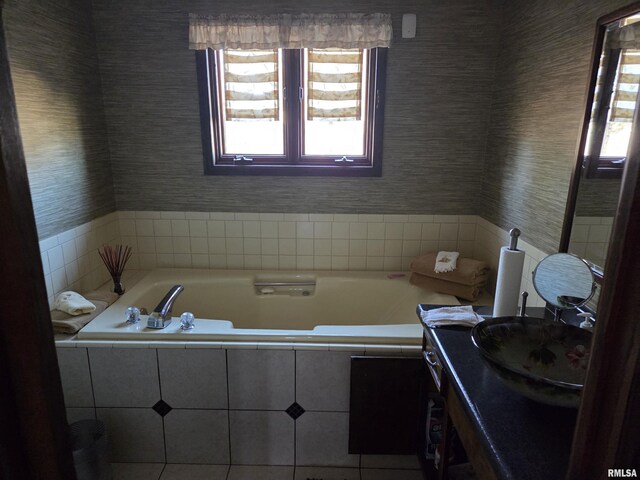 kitchen featuring light countertops, a sink, dishwasher, and light tile patterned flooring