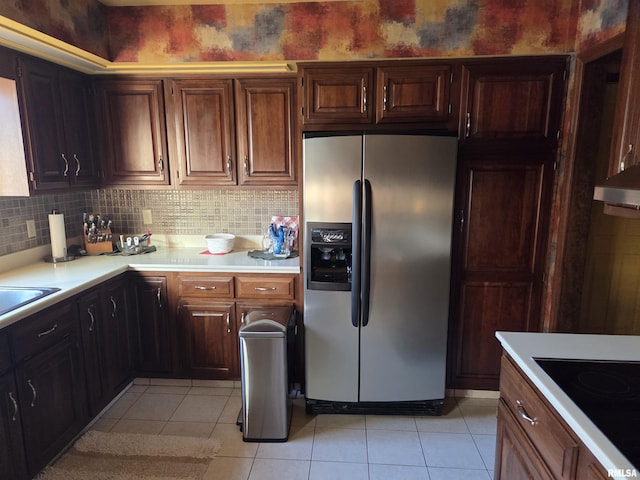 kitchen with light tile patterned floors, light countertops, and stainless steel refrigerator with ice dispenser