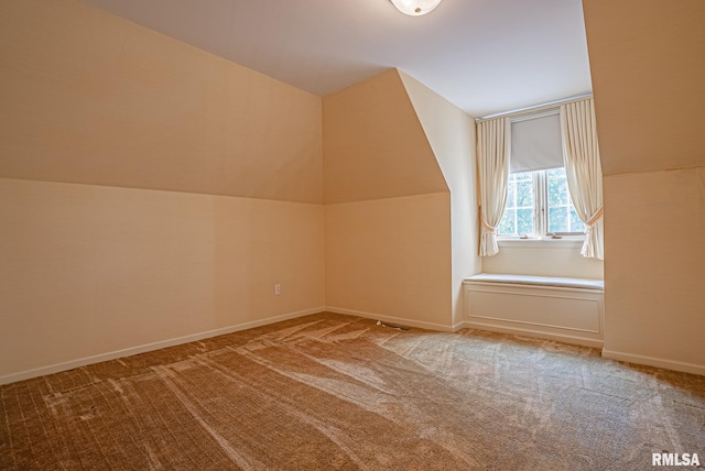 bonus room with carpet, baseboards, and vaulted ceiling