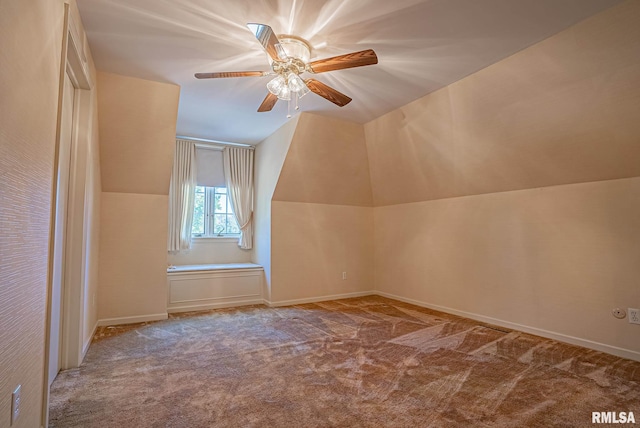 additional living space with carpet floors, vaulted ceiling, and a ceiling fan