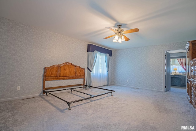 bedroom with wallpapered walls, carpet, and baseboards