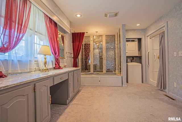 bathroom featuring wallpapered walls, recessed lighting, visible vents, and stacked washer / drying machine