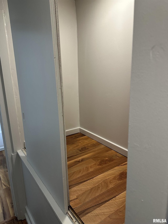 stairs featuring wood finished floors and baseboards