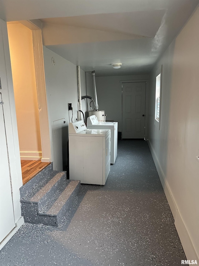washroom with baseboards, laundry area, and washer and clothes dryer