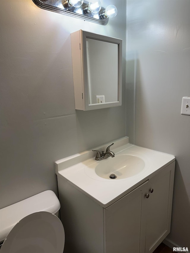 bathroom featuring toilet and vanity