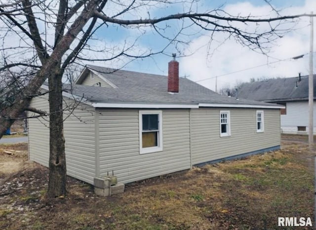 back of property featuring a chimney