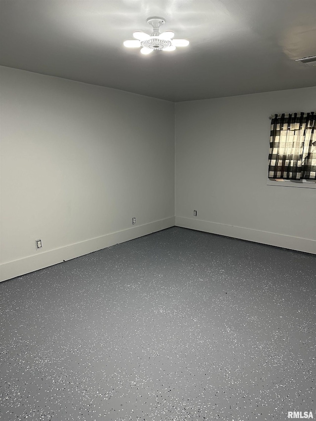 unfurnished room with an inviting chandelier, baseboards, visible vents, and dark speckled floor