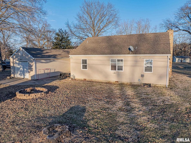 view of property exterior with a garage, a shingled roof, and a chimney