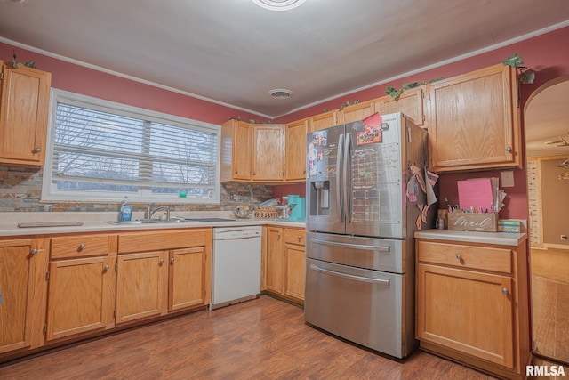 kitchen featuring light countertops, visible vents, a sink, stainless steel fridge, and dishwasher