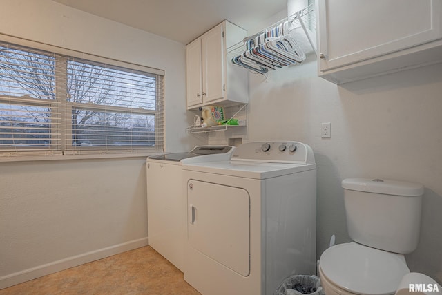 washroom featuring laundry area, baseboards, and separate washer and dryer