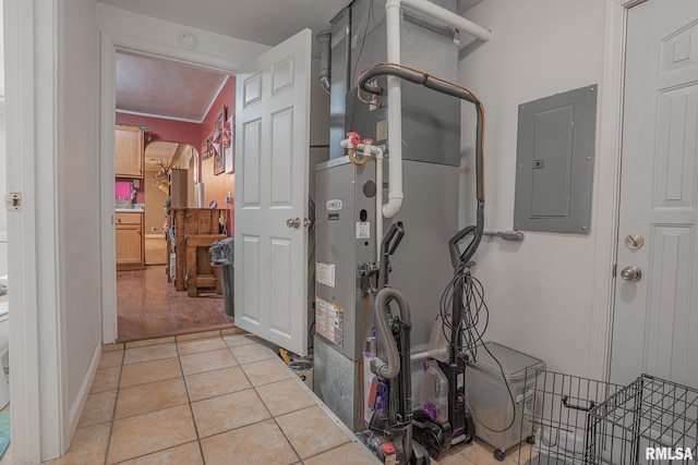 utility room featuring electric panel and heating unit