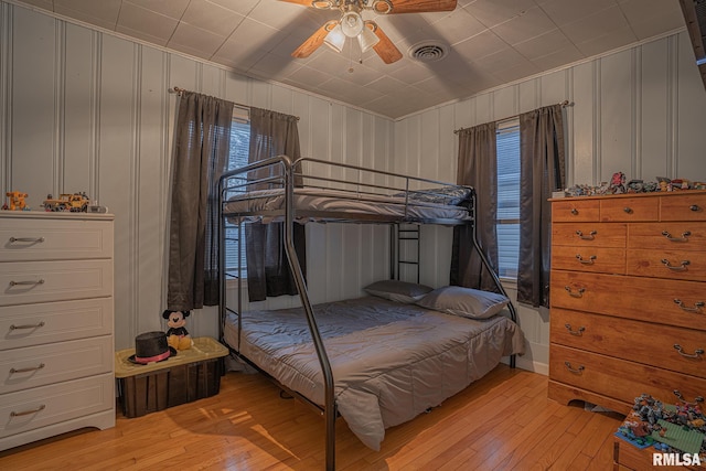 bedroom featuring visible vents, ceiling fan, and light wood-style flooring