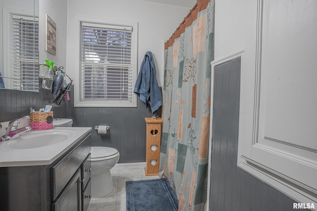 full bathroom featuring a shower with shower curtain, tile patterned flooring, vanity, and toilet