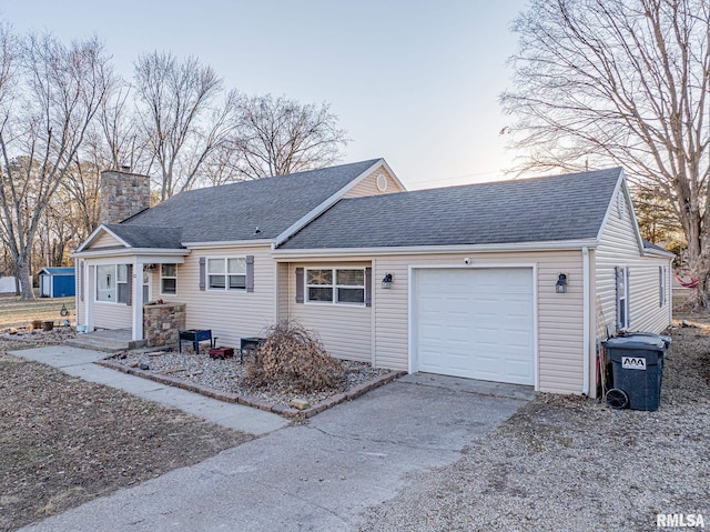 ranch-style house featuring a shingled roof, driveway, a chimney, and an attached garage