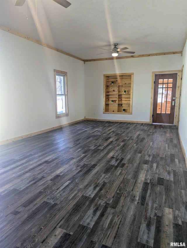 unfurnished living room featuring dark wood finished floors, baseboards, and ceiling fan