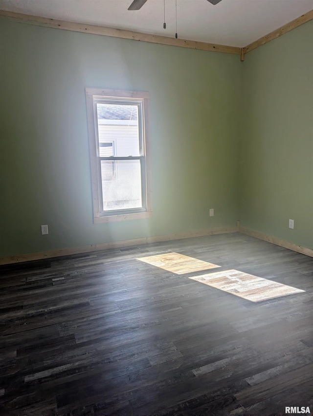 empty room featuring ceiling fan, wood finished floors, and baseboards