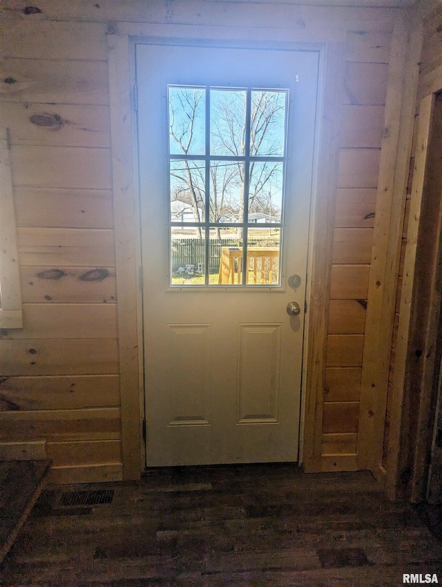 doorway with wooden walls