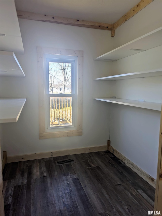 interior space with wood finished floors, visible vents, and baseboards