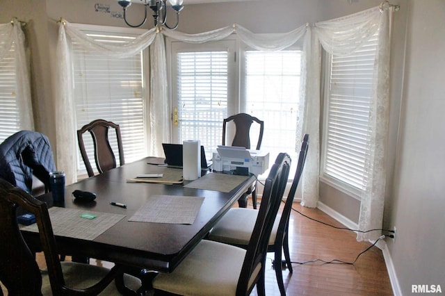 dining area featuring light wood-type flooring and baseboards