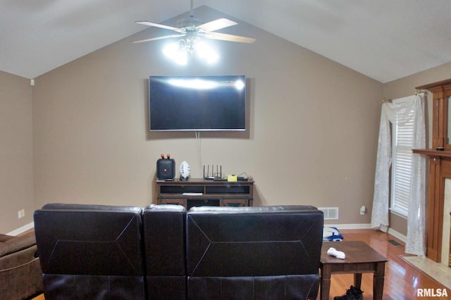 living room with baseboards, visible vents, ceiling fan, wood finished floors, and vaulted ceiling