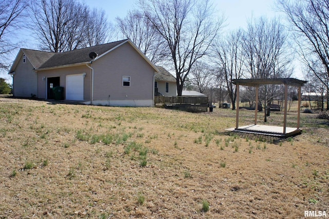 view of home's exterior featuring a garage and a wooden deck