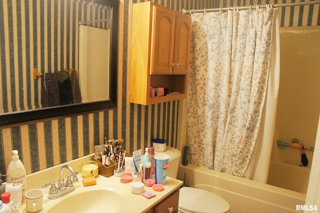 full bathroom with toilet, wallpapered walls, shower / bathtub combination with curtain, and vanity