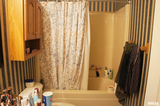 full bath featuring shower / bath combo with shower curtain and wallpapered walls