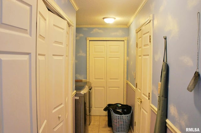 laundry room featuring ornamental molding, laundry area, light tile patterned flooring, and independent washer and dryer