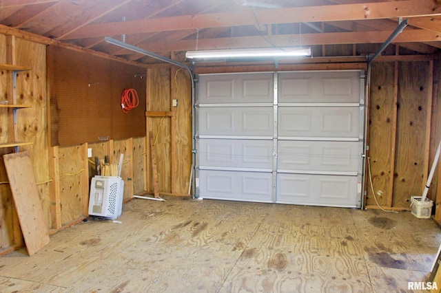 garage featuring wood walls