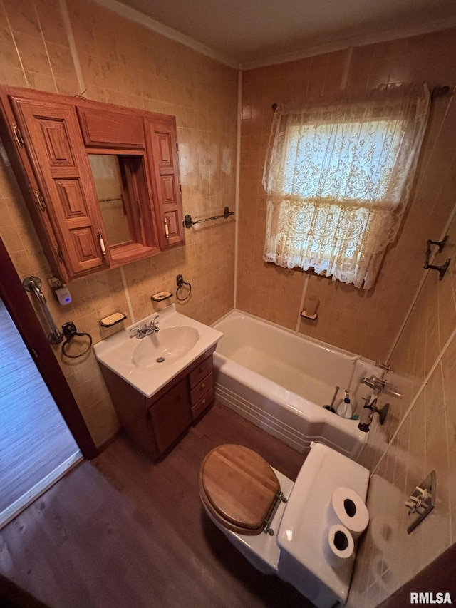 full bath with a tub to relax in, a sink, tile walls, backsplash, and crown molding