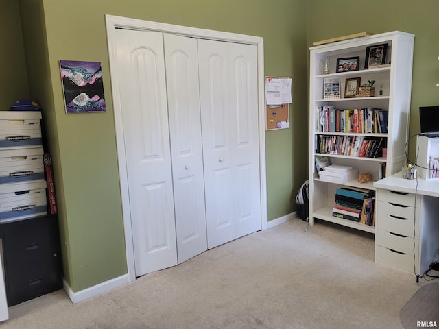 interior space with carpet floors and baseboards