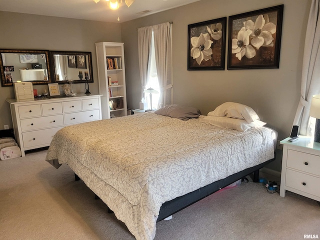 bedroom featuring light colored carpet