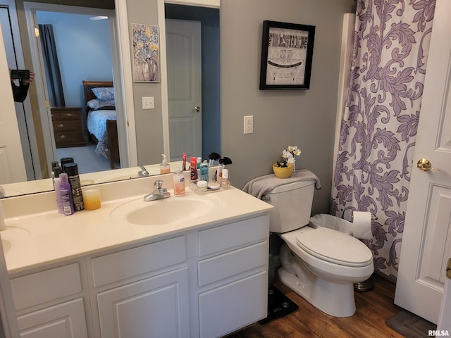 full bathroom with vanity, toilet, and wood finished floors